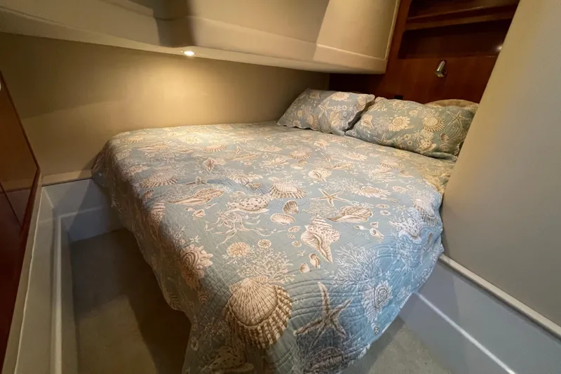 Slide: The Image of Cozy bedroom in 2003 Carver 36 Sport Sedan with nautical-themed bedding. - 20