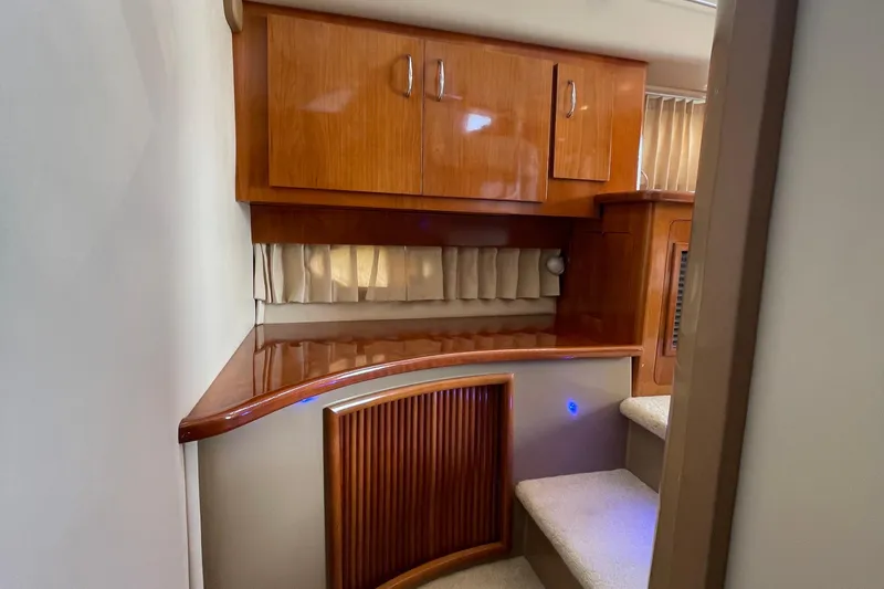 Slide: The Image of Interior of 2003 Carver 36 Sport Sedan with wooden cabinetry and carpeted stairs. - 25