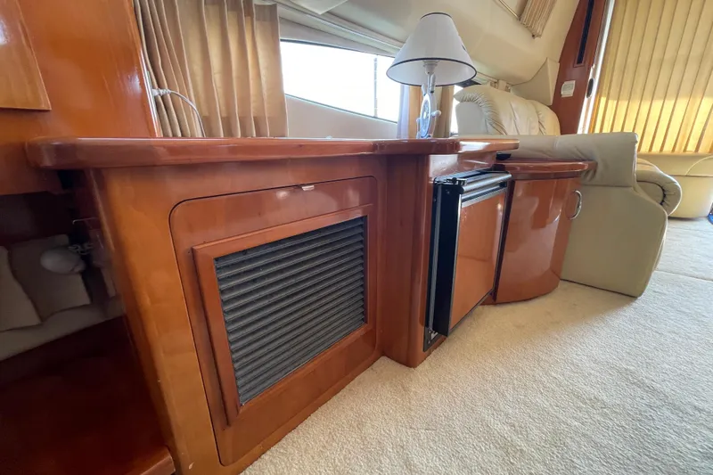 Slide: The Image of Interior of 2003 Carver 36 Sport Sedan with wooden cabinetry and mini fridge. - 29