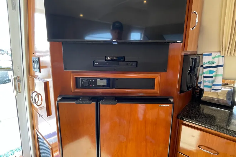 Slide: The Image of Interior of 2003 Carver 36 Sport Sedan with TV, audio system, and mini fridge. - 30