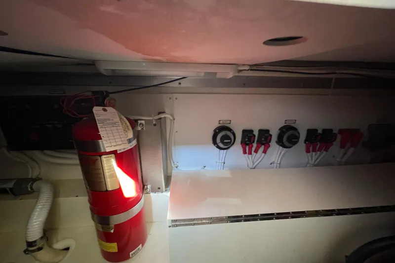 Slide: The Image of 2003 Carver 36 Sport Sedan engine room with fire extinguisher and control panel. - 34