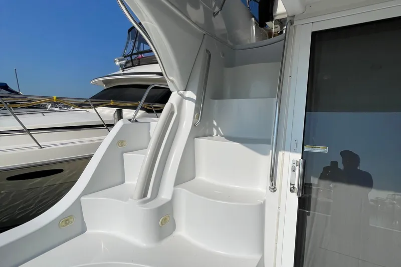 Slide: The Image of 2003 Carver 36 Sport Sedan yacht with sleek white exterior and modern design. - 36