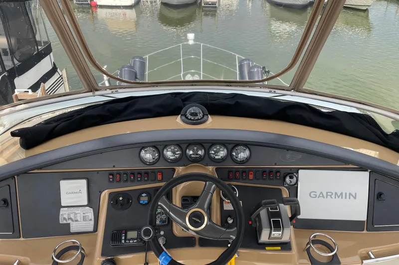 Slide: The Image of 2003 Carver 36 Sport Sedan helm with Garmin navigation, docked at marina. - 38
