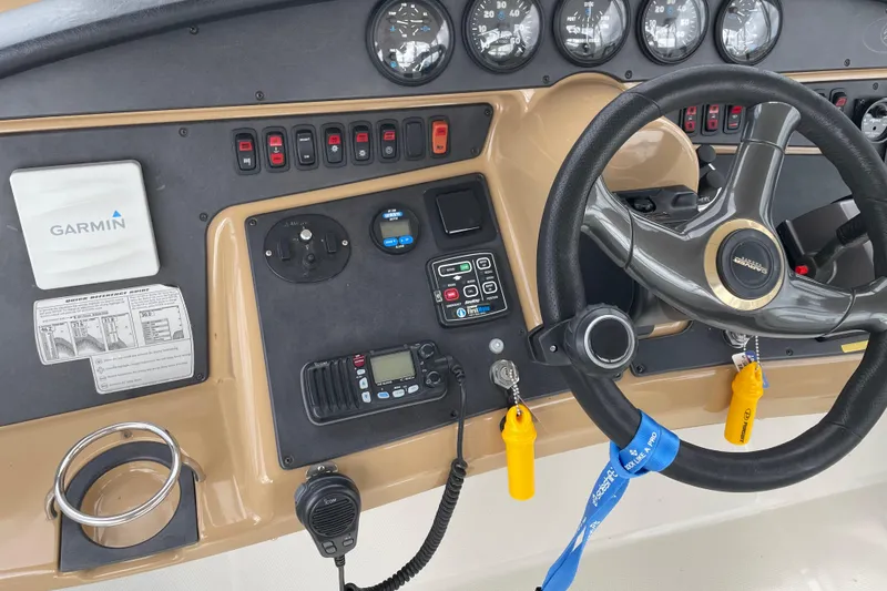 Slide: The Image of 2003 Carver 36 Sport Sedan dashboard with Garmin navigation and steering wheel. - 39