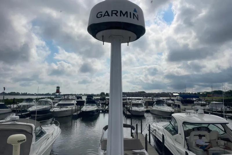 Slide: The Image of Marina with boats, including a 2003 Carver 36 Sport Sedan, under cloudy skies. - 44