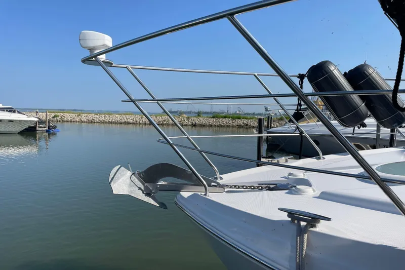 Slide: The Image of 2003 Carver 36 Sport Sedan yacht anchored in a serene marina setting. - 6