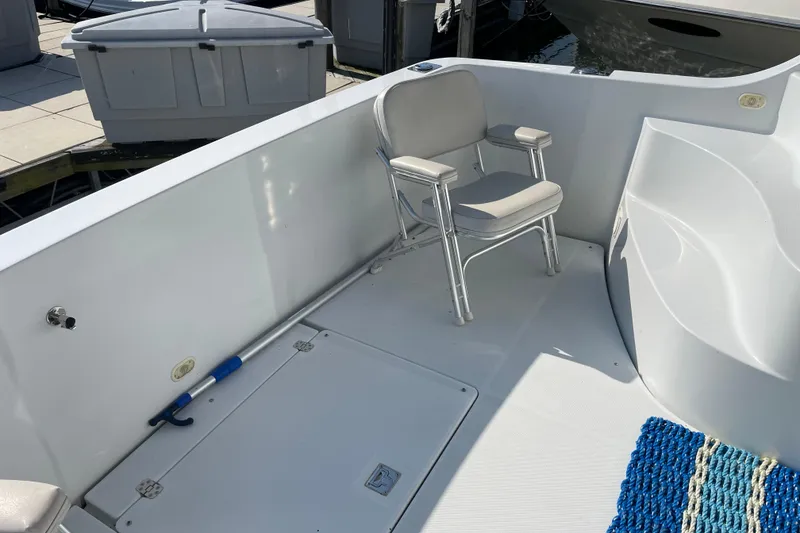 Slide: The Image of 2003 Carver 36 Sport Sedan boat deck with chair and blue mat. - 7