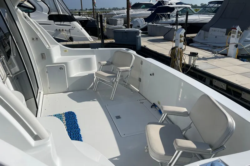 Slide: The Image of 2003 Carver 36 Sport Sedan yacht deck with chairs at marina. - 8