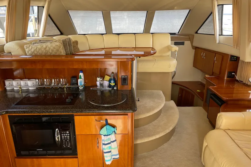 Slide: The Image of Luxurious interior of 2003 Carver 36 Sport Sedan with modern kitchen and seating area. - 9