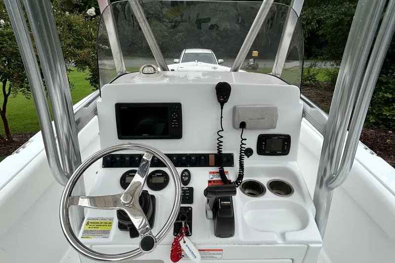 Slide: The Image of 2016 Sea Hunt Ultra 210 boat console with steering wheel, controls, and navigation equipment. - 15