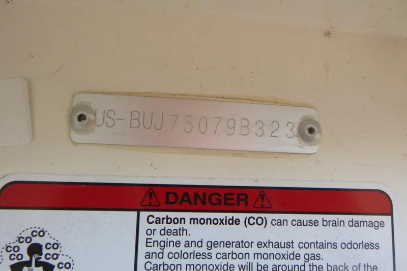 Slide: The Image of 2023 Mako Pro Skiff 15 CC hull identification number and carbon monoxide warning label. - 11