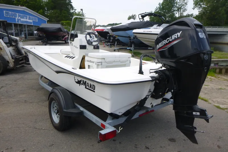 Slide: The Image of 2023 Mako Pro Skiff 15 CC boat with Mercury 60 engine on trailer. - 3