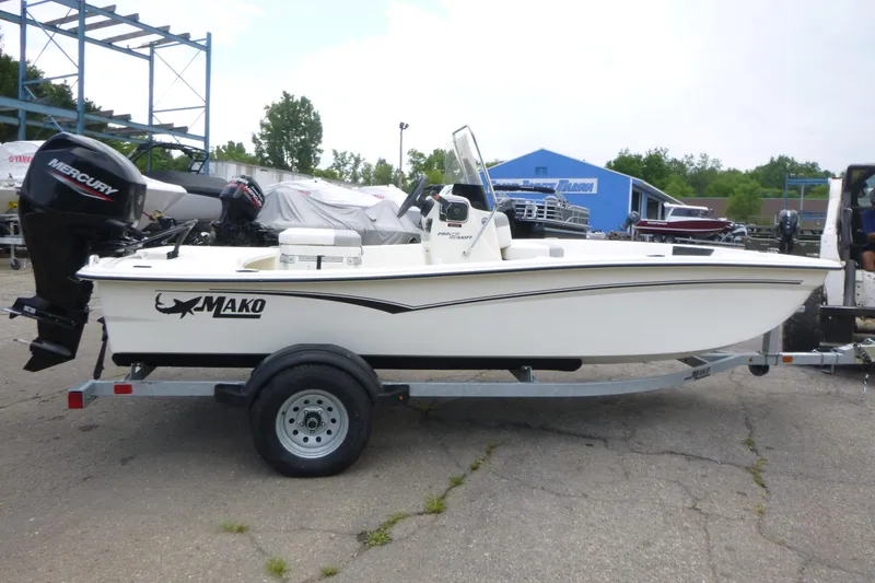 Slide: The Image of 2023 Mako Pro Skiff 15 CC boat on trailer with Mercury outboard motor. - 4