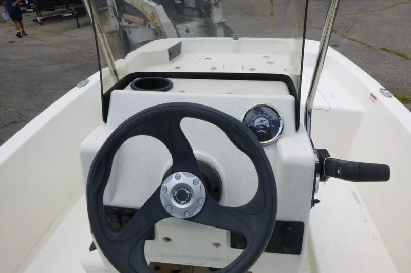 Slide: The Image of 2023 Mako Pro Skiff 15 CC boat console with steering wheel and gauge. - 8