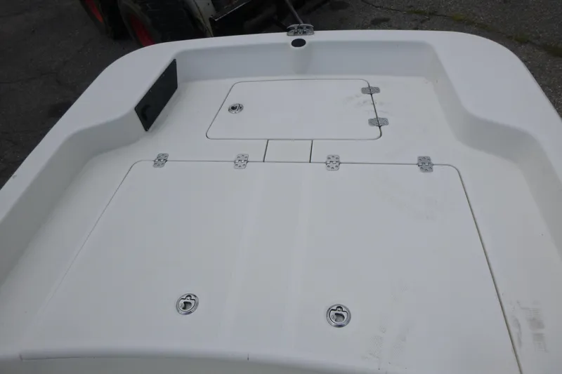 Slide: The Image of 2023 Mako Pro Skiff 15 CC boat deck with storage compartments. - 9