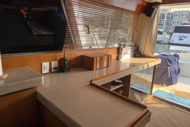 Slide: The Image of Interior of 1988 Neptune 42 Sedan yacht with wooden cabinetry and marina view. - 34