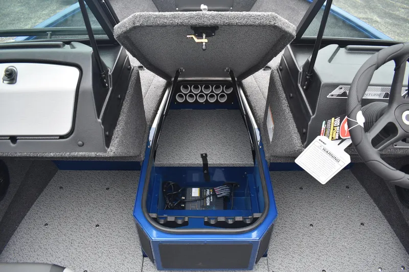 Slide: The Image of 2026 Lund 1775 Adventure Sport boat interior with open storage compartment. - 10