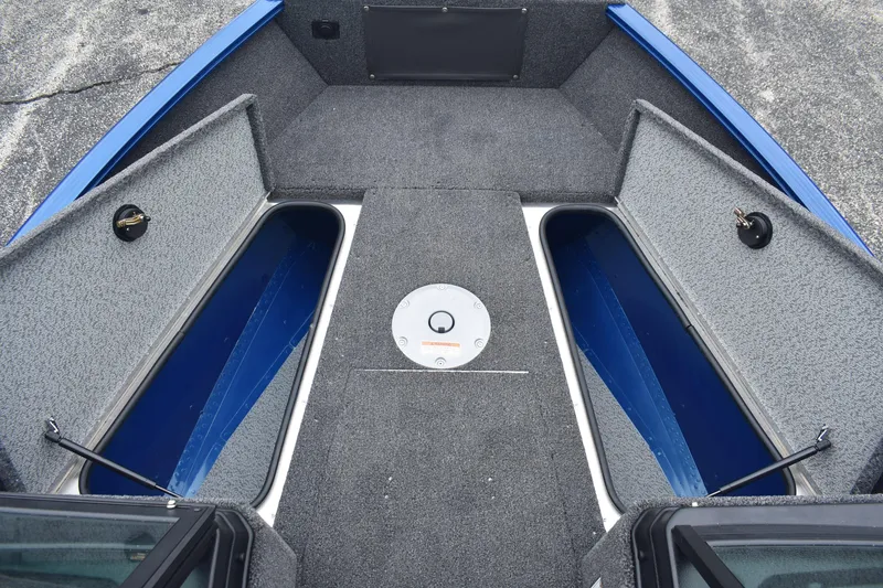 Slide: The Image of 2026 Lund 1775 Adventure Sport boat interior with open storage compartments. - 13