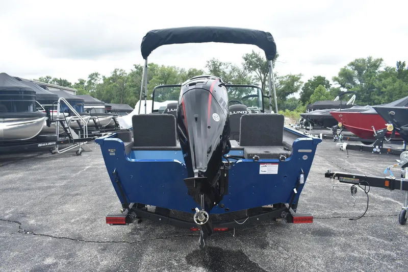 Slide: The Image of 2026 Lund 1775 Adventure Sport boat, rear view, parked on a trailer in a lot. - 3