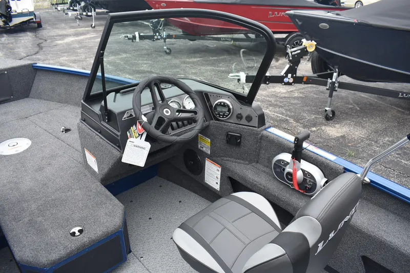 Slide: The Image of 2026 Lund 1775 Adventure Sport boat interior with steering wheel and dashboard controls. - 6