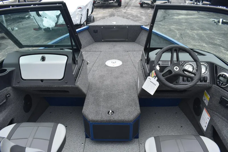 Slide: The Image of 2026 Lund 1775 Adventure Sport boat interior with steering wheel and seating. - 7