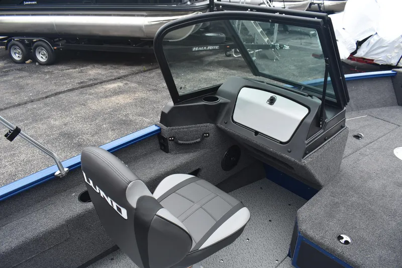 Slide: The Image of 2026 Lund 1775 Adventure Sport boat interior with seating and dashboard. - 8