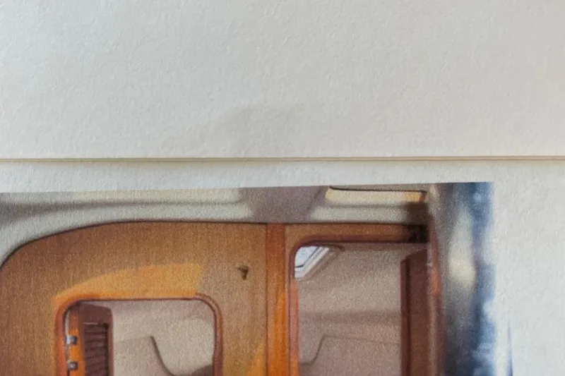 Slide: The Image of Interior view of a 1998 Hunter 340 sailboat, showcasing wooden cabin details. - 11