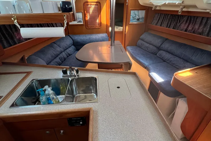 Slide: The Image of Interior of a 1998 Hunter 340 sailboat with kitchen and seating area. - 16