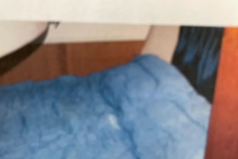 Slide: The Image of Interior of a 1998 Hunter 340 sailboat with blue bedding. - 20