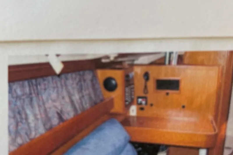 Slide: The Image of 1998 Hunter 340 sailboat interior with navigation station and seating area. - 23