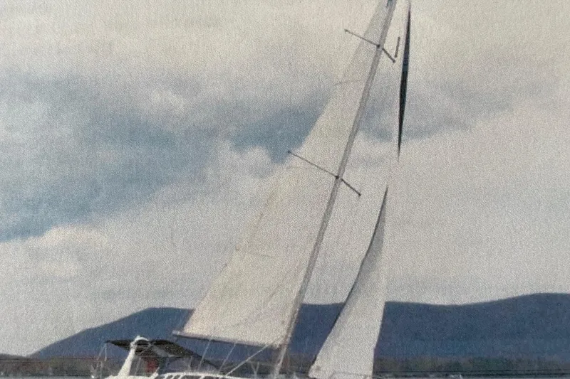 Slide: The Image of Sailboat Hunter 340 from 1998 on water with mountains in background. - 4