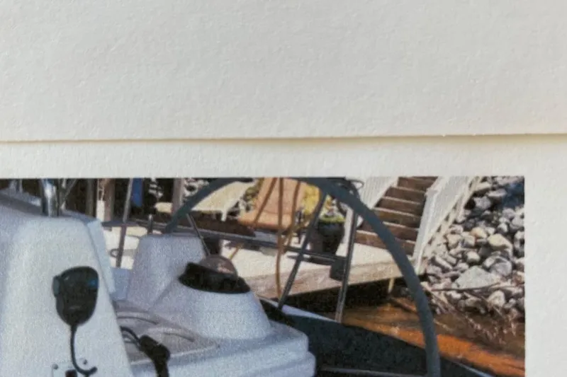 Slide: The Image of 1998 Hunter 340 sailboat helm with dock and stairs in background. - 7