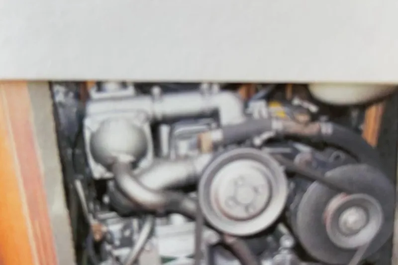 Slide: The Image of Engine compartment of a 1998 Hunter 340 sailboat, showing mechanical components and belts. - 9