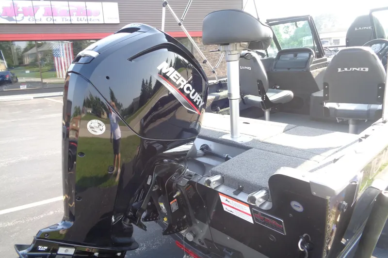 Slide: The Image of 2022 Lund 1675 Adventure Sport boat with Mercury outboard motor, parked outdoors. - 16