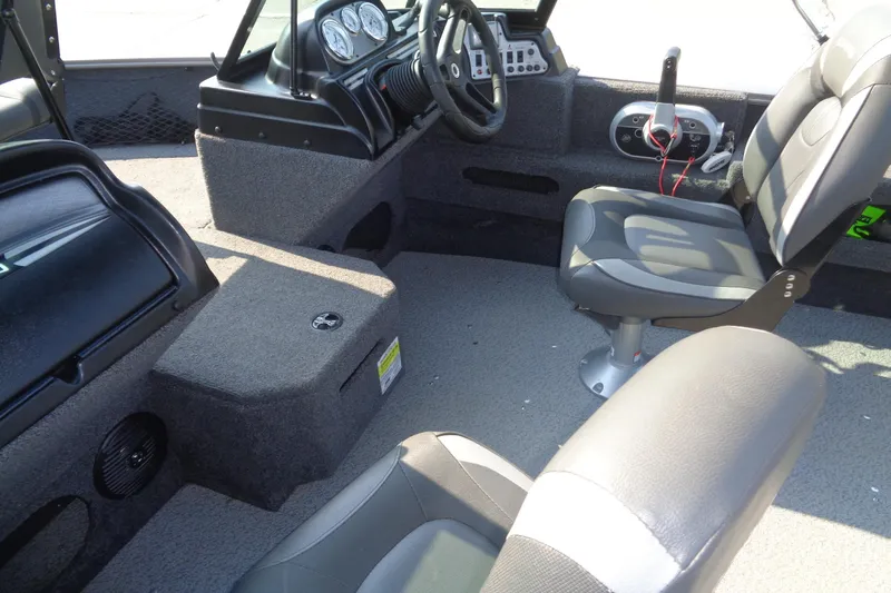 Slide: The Image of 2022 Lund 1675 Adventure Sport boat interior with seating and dashboard controls. - 17