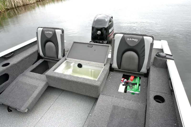 Slide: The Image of Manufacturer Provided Image: 2022 Lund 1675 Adventure Sport boat interior with storage compartments and Mercury outboard motor. - 23
