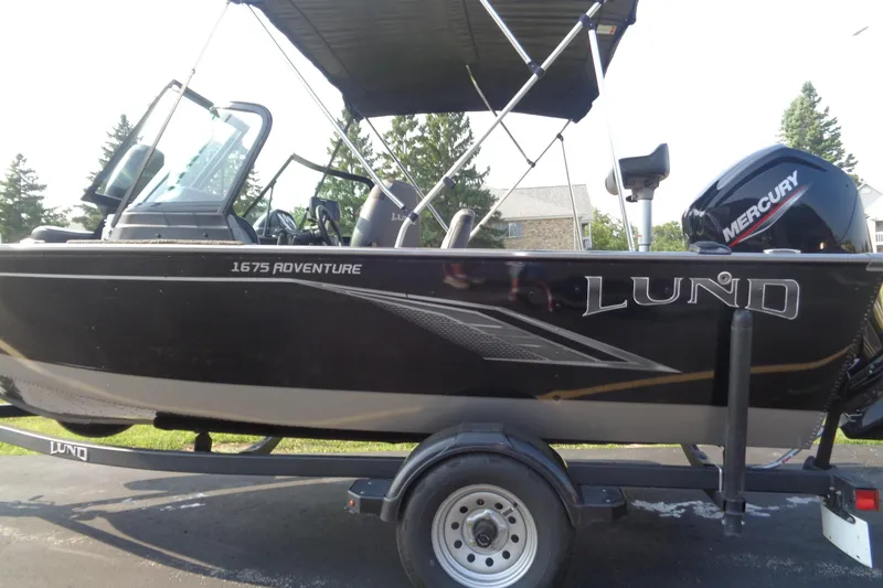 Slide: The Image of 2022 Lund 1675 Adventure Sport boat with Mercury engine on trailer. - 3