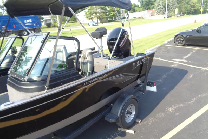 Slide: The Image of 2022 Lund 1675 Adventure Sport boat on trailer in parking lot. - 6