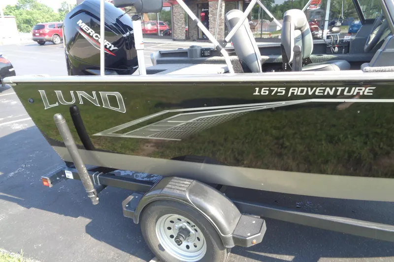 Slide: The Image of 2022 Lund 1675 Adventure Sport boat on trailer, featuring Mercury outboard motor. - 7