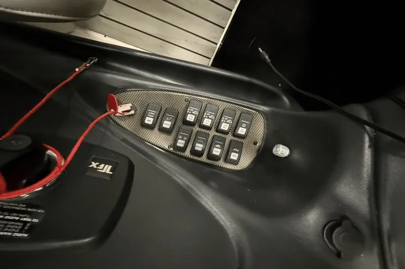 Slide: The Image of Control panel of a 2004 Centurion Avalanche C4 boat with multiple switches. - 11