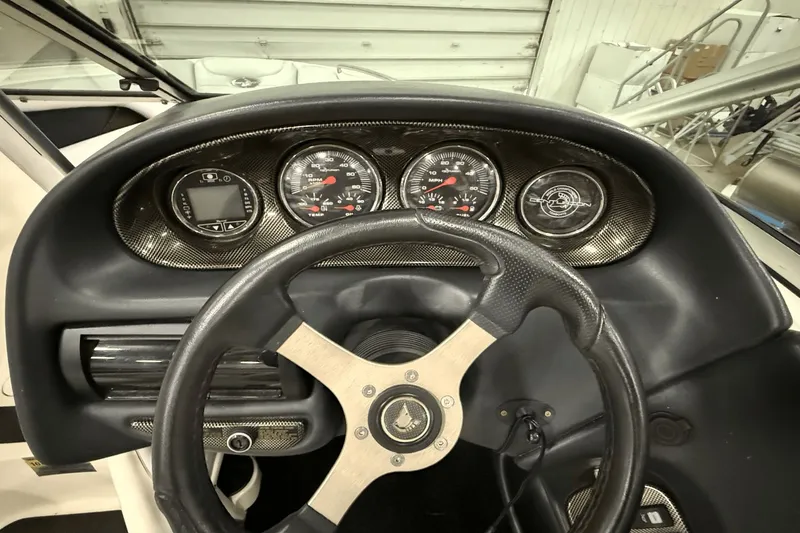 Slide: The Image of Dashboard of 2004 Centurion Avalanche C4 boat with steering wheel and gauges. - 12