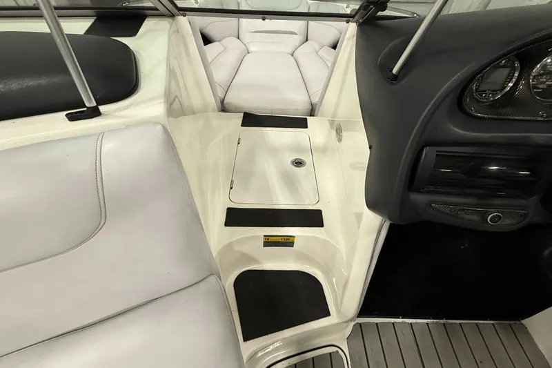 Slide: The Image of 2004 Centurion Avalanche C4 boat interior with white seating and dashboard controls. - 13