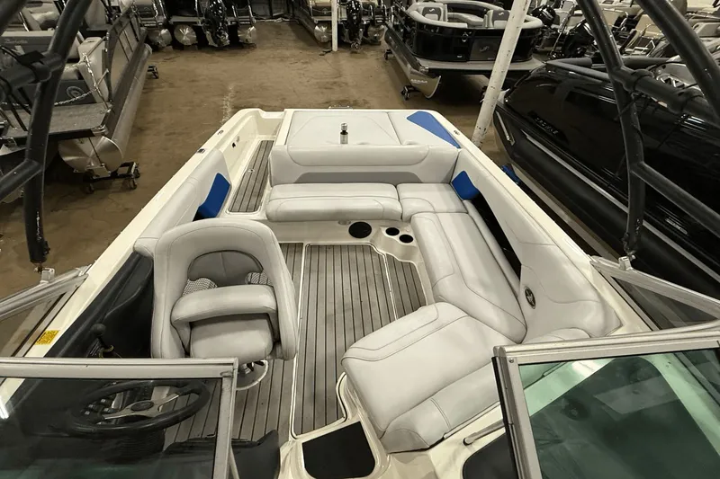Slide: The Image of 2004 Centurion Avalanche C4 boat interior with white seating and wood flooring. - 17