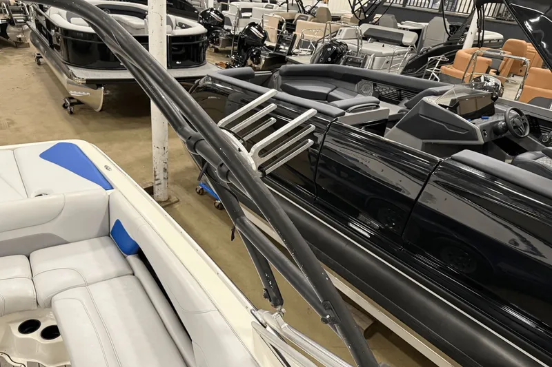 Slide: The Image of 2004 Centurion Avalanche C4 boat interior with seating and wakeboard rack in showroom. - 18