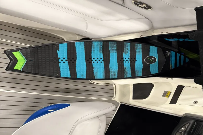 Slide: The Image of Wakesurf board on 2004 Centurion Avalanche C4 boat with striped blue and black design. - 21