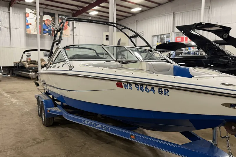 Slide: The Image of 2004 Centurion Avalanche C4 boat on trailer in indoor showroom. - 22