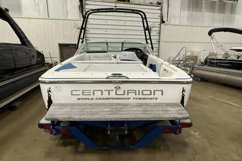 Slide: The Image of 2004 Centurion Avalanche C4 towboat in storage, rear view with branding visible. - 3