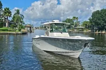 Slide: The Image of 2022 Grady-White Canyon 336 boat cruising on a scenic waterway. - 2