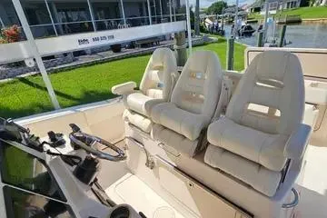 Slide: The Image of 2022 Grady-White Canyon 336 boat interior with plush seating and steering wheel. - 24