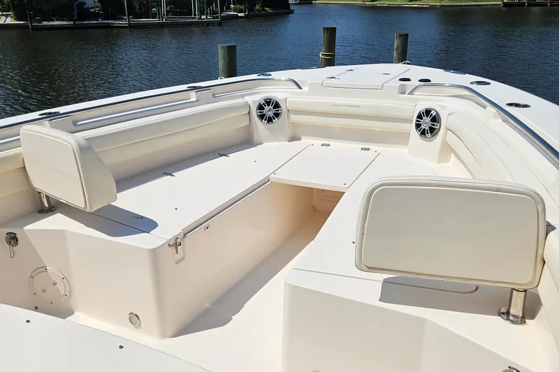 Slide: The Image of 2022 Grady-White Canyon 336 boat interior with seating and speakers by the water. - 27